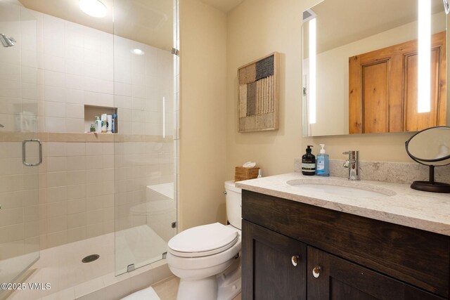 bathroom featuring walk in shower, vanity, and toilet