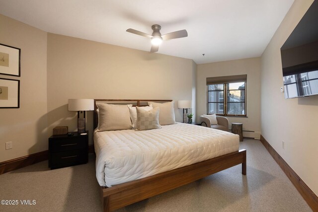 carpeted bedroom with ceiling fan and a baseboard heating unit