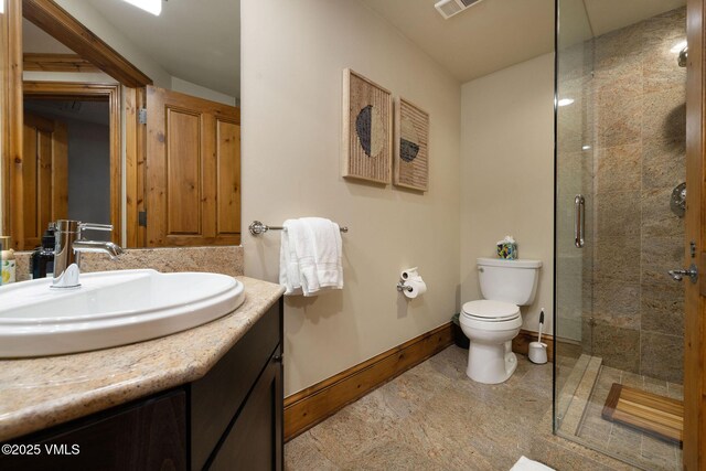 bathroom featuring vanity, toilet, and walk in shower