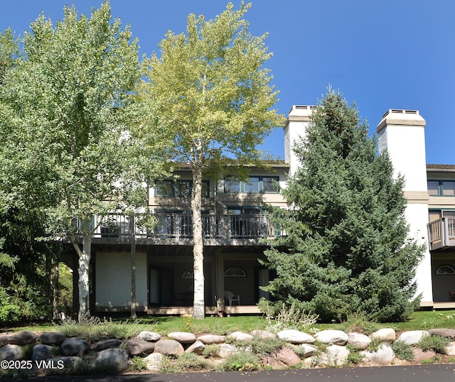 931 Singletree Rd Unit 21, Edwards, CO 81632 - back of house with a wooden deck and a chimney