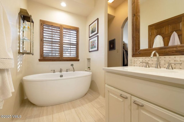 50 Andover Trl, Edwards, CO 81632 - full bathroom with vanity, a soaking tub, backsplash, baseboards, and recessed lighting
