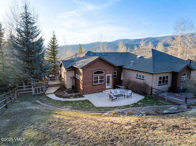 50 Andover Trl, Edwards, CO 81632 - back of property with a deck with mountain view, a shingled roof, a fenced backyard, a patio, and stucco siding