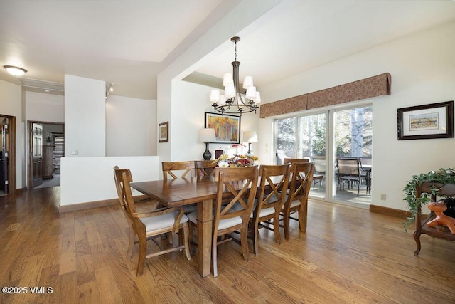 50 Andover Trl, Edwards, CO 81632 - dining space featuring baseboards, wood finished floors, and an inviting chandelier