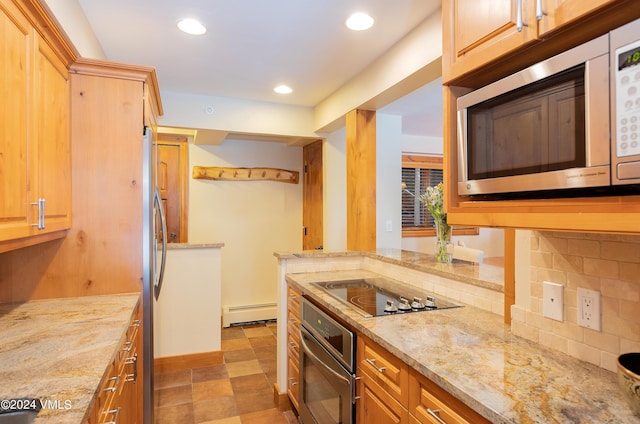 kitchen with light stone countertops, appliances with stainless steel finishes, a baseboard heating unit, and decorative backsplash