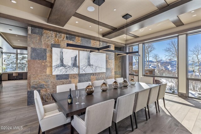 dining space featuring wood finished floors, coffered ceiling, recessed lighting, expansive windows, and beamed ceiling