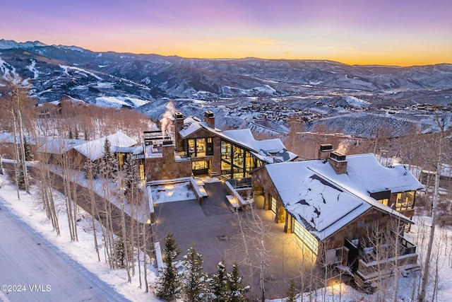 snowy aerial view featuring a mountain view