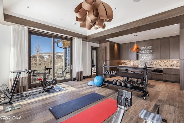 workout room featuring light wood-type flooring