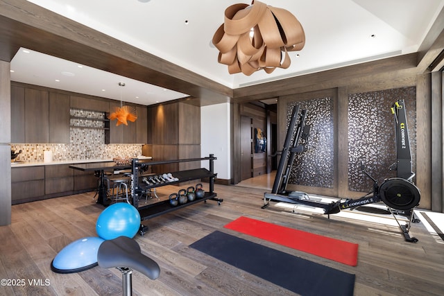 exercise area with light wood-style flooring and recessed lighting