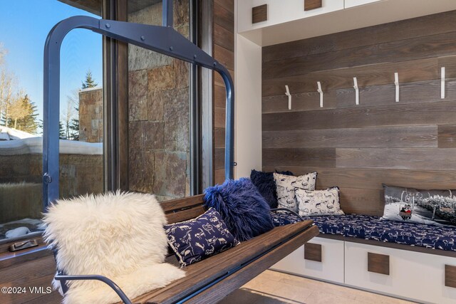 mudroom featuring arched walkways and wooden walls