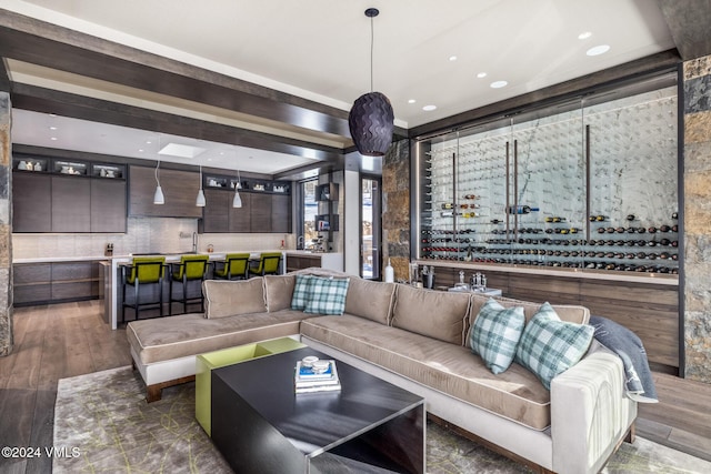 living room with recessed lighting, wet bar, and wood finished floors