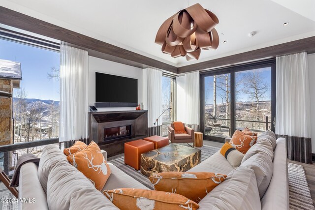 living area with a wealth of natural light and a glass covered fireplace