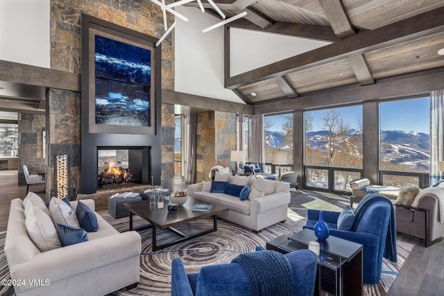 living room featuring wood finished floors, high vaulted ceiling, beam ceiling, a multi sided fireplace, and wooden ceiling