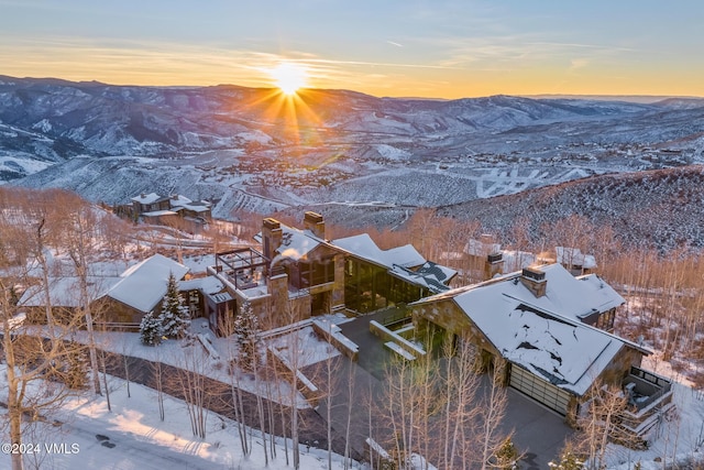 snowy aerial view with a mountain view