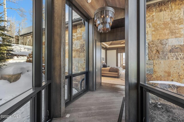 interior space featuring dark wood finished floors and a notable chandelier