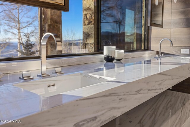 room details with stone countertops and a sink