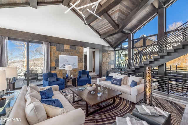 living area featuring stairway, high vaulted ceiling, and beamed ceiling