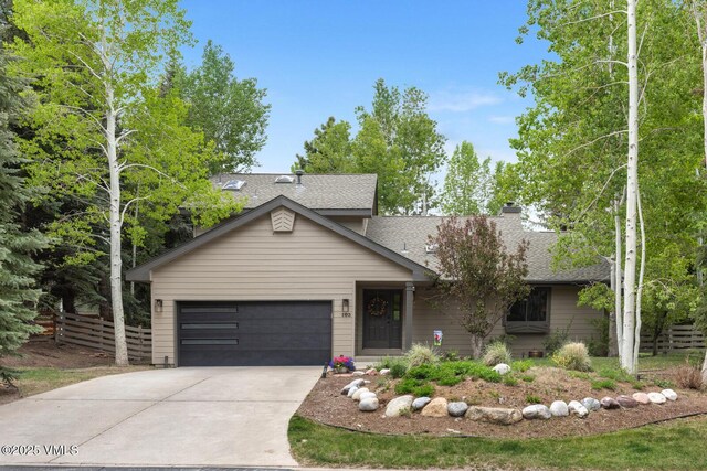 103 Meile Ln, Edwards, CO 81632 - view of front of property with an attached garage, concrete driveway, roof with shingles, and a chimney