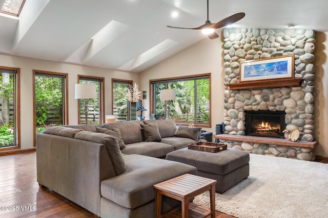 103 Meile Ln, Edwards, CO 81632 - living room featuring a skylight, vaulted ceiling, wood finished floors, a fireplace, and a ceiling fan