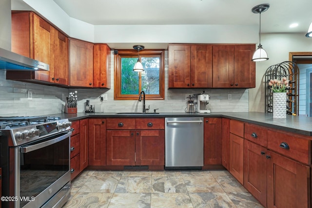 103 Meile Ln, Edwards, CO 81632 - kitchen with wall chimney range hood, appliances with stainless steel finishes, a sink, dark countertops, and tasteful backsplash