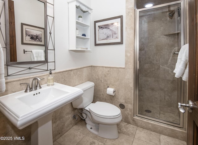 2241 Tahoe Dr, Vail, CO 81657 - bathroom with toilet, tile walls, a stall shower, tile patterned flooring, and a wainscoted wall