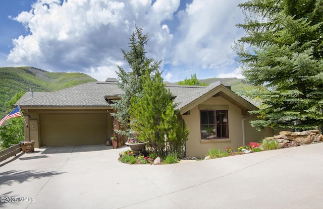 2241 Tahoe Dr, Vail, CO 81657 - view of front of property with an attached garage, driveway, stucco siding, and a mountain view