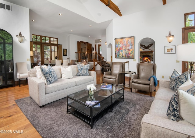 2241 Tahoe Dr, Vail, CO 81657 - living area with arched walkways, wood finished floors, high vaulted ceiling, and recessed lighting