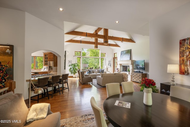 2241 Tahoe Dr, Vail, CO 81657 - dining space featuring recessed lighting, arched walkways, wood finished floors, beam ceiling, and high vaulted ceiling