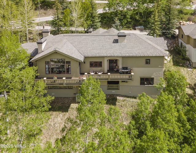 2241 Tahoe Dr, Vail, CO 81657 - back of property with a chimney, roof with shingles, and a wooden deck