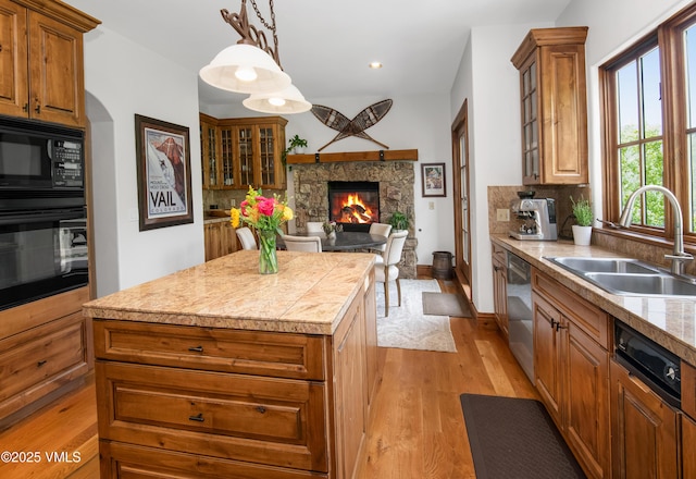 2241 Tahoe Dr, Vail, CO 81657 - kitchen with black appliances, a sink, a kitchen island, brown cabinetry, and recessed lighting