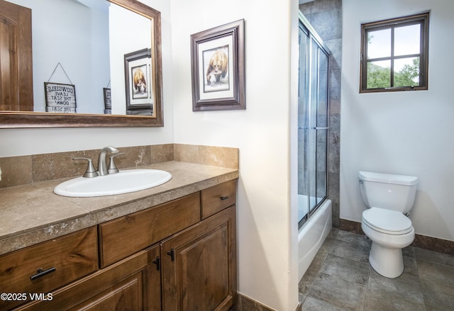2241 Tahoe Dr, Vail, CO 81657 - bathroom featuring toilet, vanity, baseboards, bath / shower combo with glass door, and tile patterned flooring