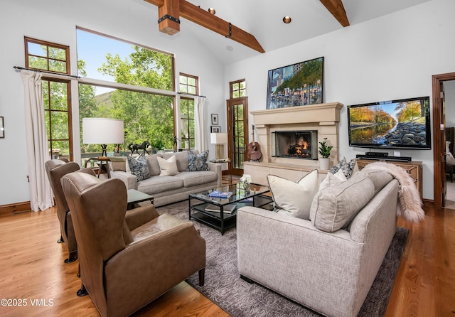 2241 Tahoe Dr, Vail, CO 81657 - living area with high vaulted ceiling, beamed ceiling, wood finished floors, a lit fireplace, and recessed lighting