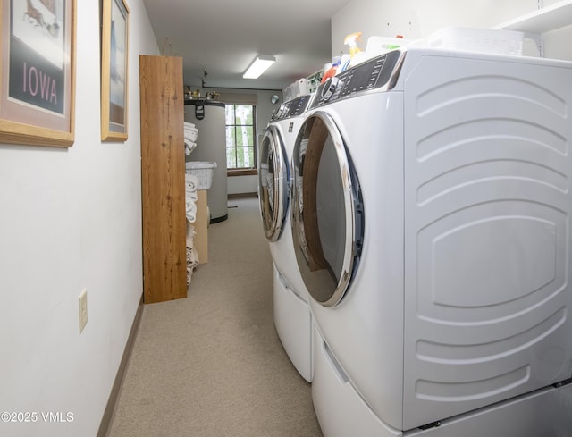 2241 Tahoe Dr, Vail, CO 81657 - laundry area with washing machine and clothes dryer, baseboards, water heater, and light carpet