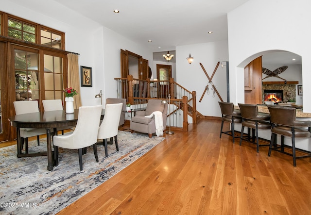 2241 Tahoe Dr, Vail, CO 81657 - dining room featuring wood finished floors, a glass covered fireplace, arched walkways, and recessed lighting