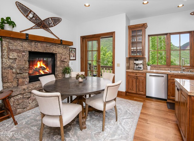 2241 Tahoe Dr, Vail, CO 81657 - dining space with light wood finished floors, a stone fireplace, and recessed lighting