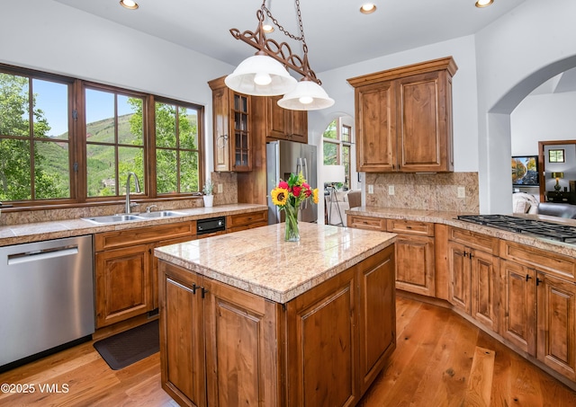 2241 Tahoe Dr, Vail, CO 81657 - kitchen with appliances with stainless steel finishes, a sink, arched walkways, brown cabinets, and recessed lighting