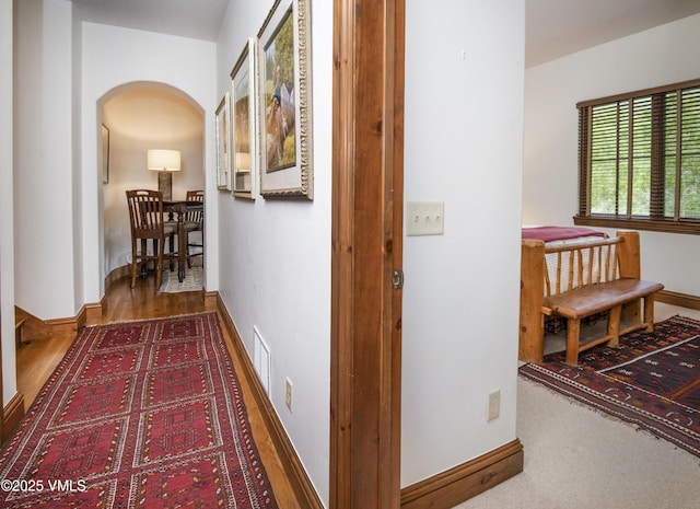 2241 Tahoe Dr, Vail, CO 81657 - corridor featuring arched walkways, baseboards, and wood finished floors