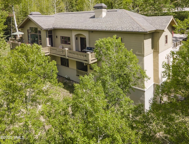 2241 Tahoe Dr, Vail, CO 81657 - rear view of property featuring a chimney and a shingled roof