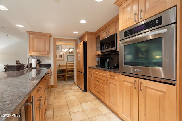 380 E Lionshead Cir Unit 160, Vail, CO 81657 - kitchen featuring stainless steel appliances, a sink, light tile patterned flooring, dark stone counters, and recessed lighting