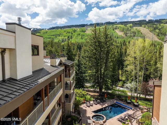 380 E Lionshead Cir Unit 160, Vail, CO 81657 - view of pool with a wooded view, a patio area, and a pool with connected hot tub