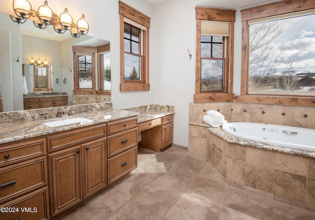 bathroom featuring a garden tub, vanity, and a notable chandelier