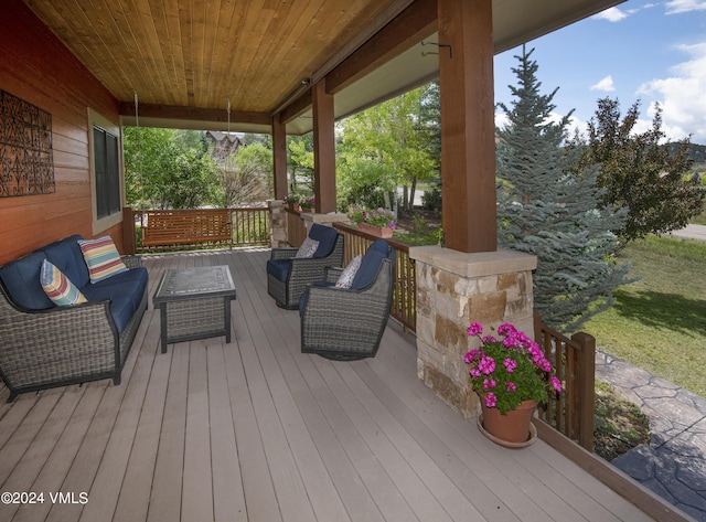 wooden terrace with a porch and outdoor lounge area