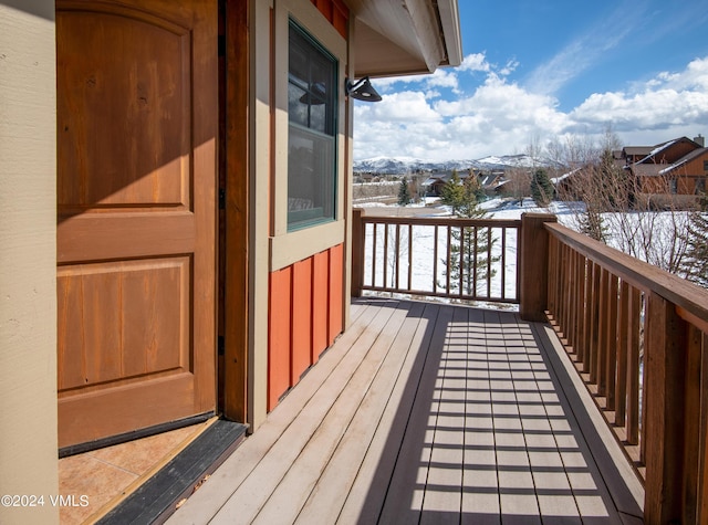 snow covered deck with a mountain view