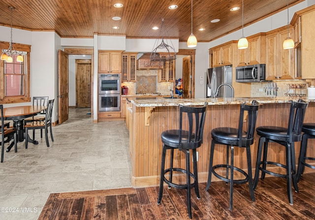 kitchen featuring stainless steel appliances, wooden ceiling, a peninsula, and light stone countertops