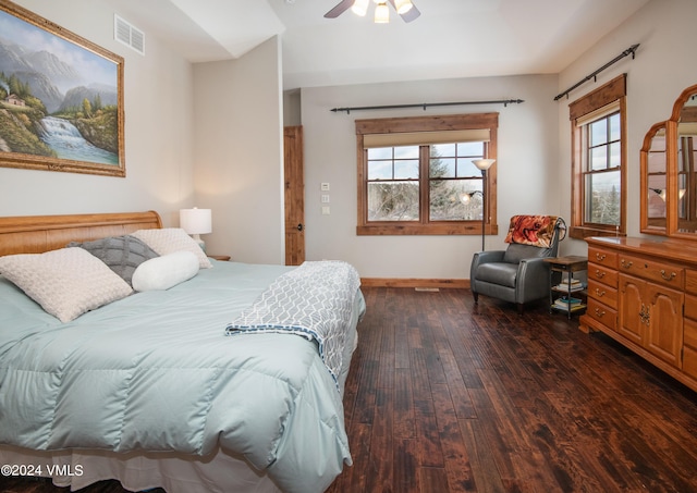 bedroom featuring multiple windows, wood-type flooring, visible vents, and baseboards