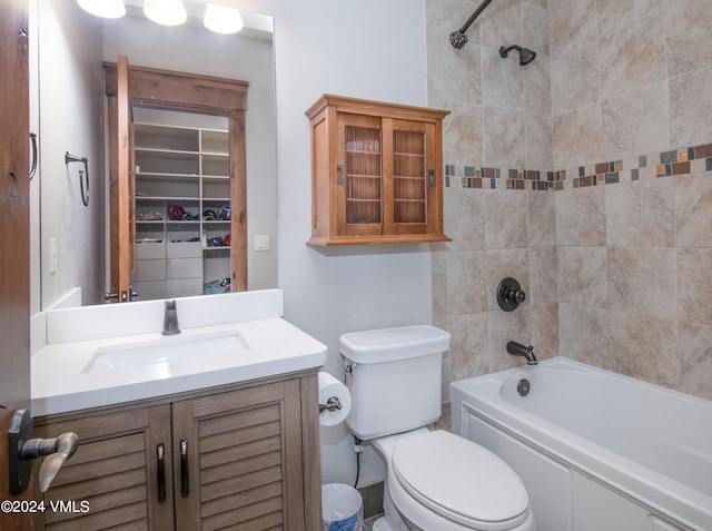 bathroom with bathtub / shower combination, vanity, and toilet