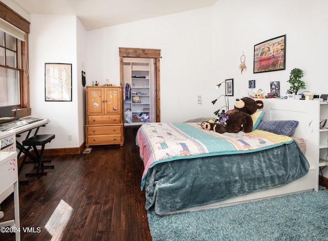 bedroom with vaulted ceiling, baseboards, and hardwood / wood-style flooring