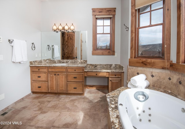 bathroom featuring visible vents, a jetted tub, and vanity