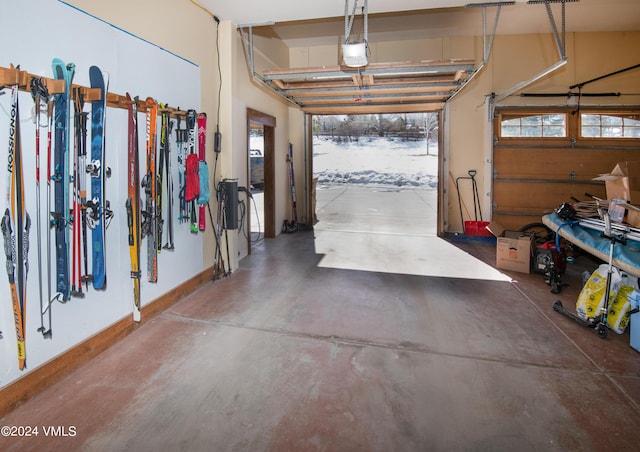 garage with a garage door opener and baseboards