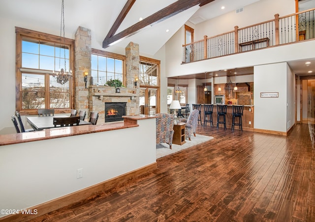 living room featuring high vaulted ceiling, a notable chandelier, visible vents, beamed ceiling, and wood-type flooring