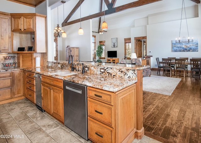 kitchen with light stone counters, a peninsula, an inviting chandelier, a sink, and stainless steel dishwasher